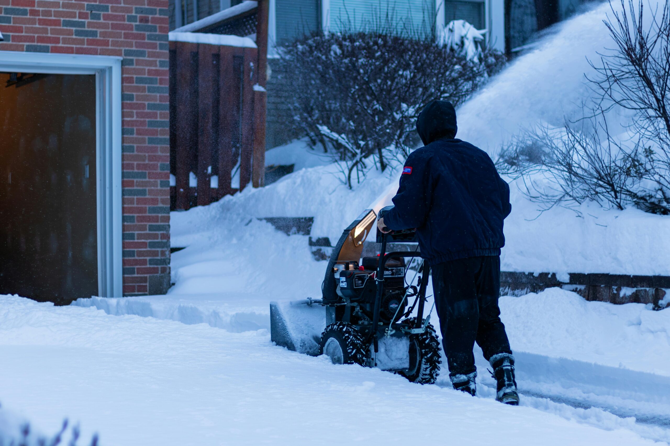Worker removing snow from clients site